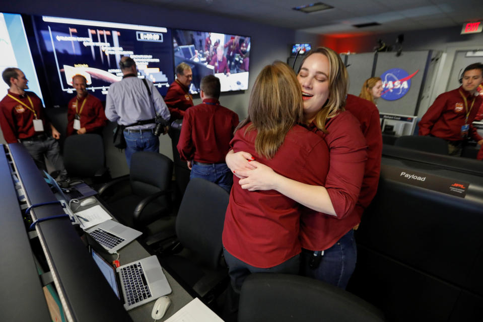 NASA engineers in the space flight operation facility at NASA’s Jet Propulsion Laboratory (JPL) hug as the spaceship InSight, , lands on the planets surface after a six-month journey. Image: Reuters