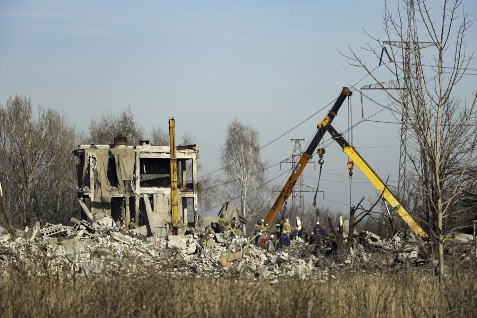 Workers clean rubbles after Ukrainian rocket strike in Makiivka, in Russian-controlled Donetsk region, eastern Ukraine, Tuesday, Jan. 3, 2023. Russia's defense ministry says 63 of its soldiers have been killed by a Ukrainian strike on a facility in the eastern Donetsk region where military personnel were stationed. (AP Photo)