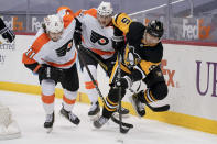 Pittsburgh Penguins' Mike Matheson (5) tries to control the puck as Philadelphia Flyers' Travis Konecny (11) and Connor Bunnaman (82) pursue during the second period of an NHL hockey game, Tuesday, March 2, 2021, in Pittsburgh. (AP Photo/Keith Srakocic)