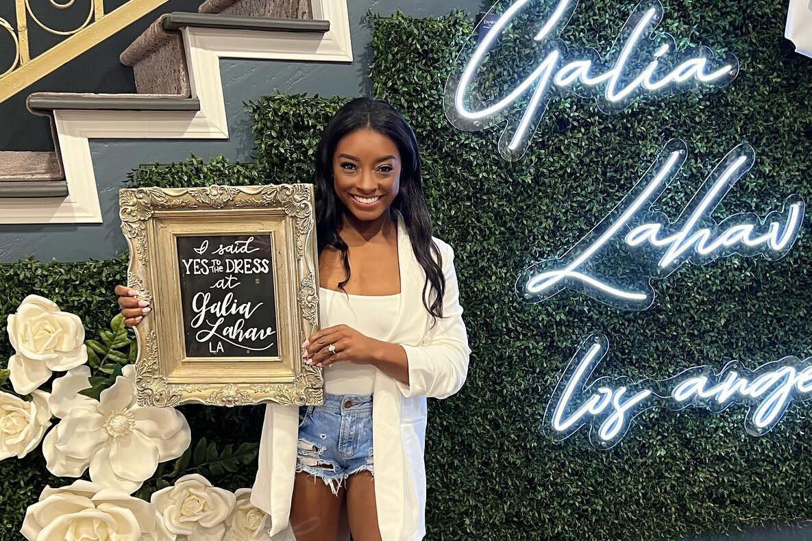 simone biles smiling in wedding dress shop