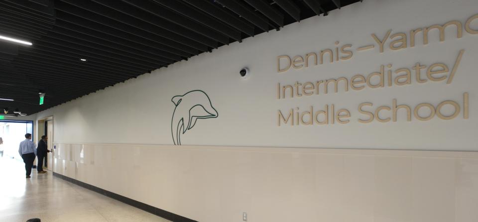The school mascot, a dolphin, greets arrivals at the Dennis-Yarmouth Intermediate Middle School on Station Avenue in South Yarmouth in April, serving students in grades 4-7. File photo