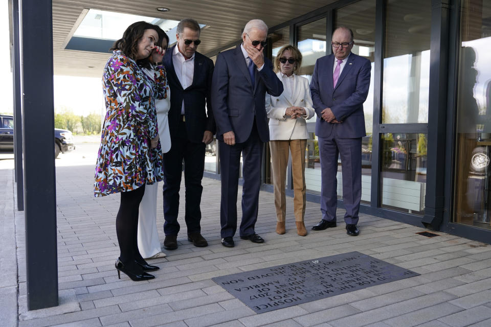 President Joe Biden stands with his son Hunter Biden and sister Valerie Biden Owens, second from right,as he looks at a plaque dedicated to his late son Beau Biden while visiting Mayo Roscommon Hospice in County Mayo, Ireland, Friday, April 14, 2023. Biden is joined by Mayo Roscommon Hospice Foundation board member Laurita Blewitt, left, CEO Martina Jennings, second from left, and Chairman Mike Smith, right. (AP Photo/Patrick Semansky)