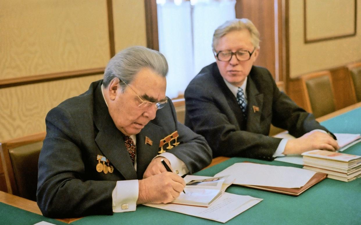 Leonid Zamyatin, right, with the Soviet leader Leonid Brezhnev, circa 1979: he would loyally deliver the official line even when it was obvious to the world that he was lying - TASS