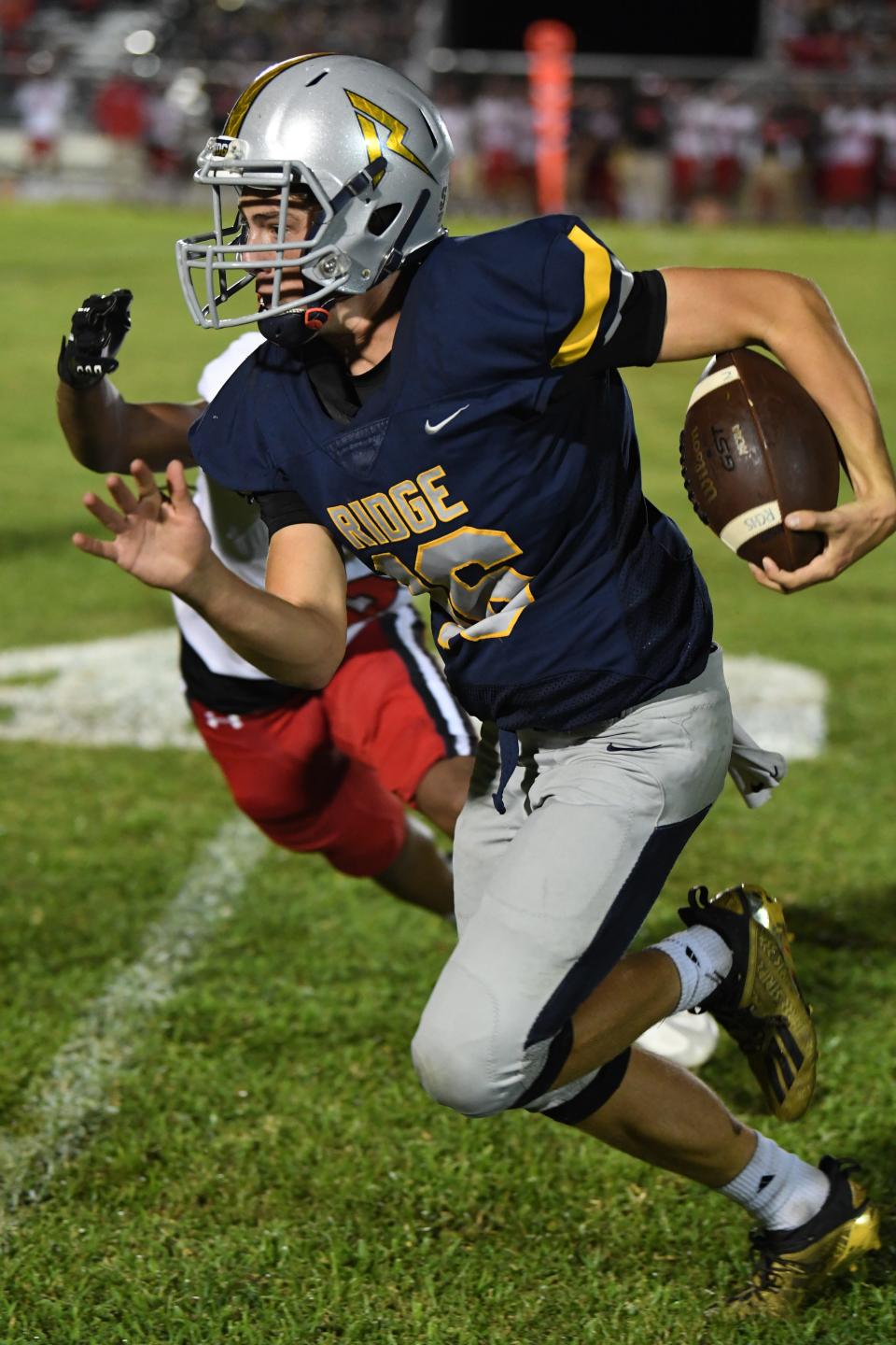 Ridge Community quarterback John Kostuch runs up the sideline in a contest vs. Kathleen. Ridge went on to win 21-0 in the kickoff classic. Andreaj Lott.