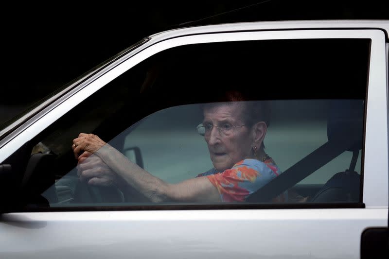 An elderly woman drives her car through the streets of Cartigliano