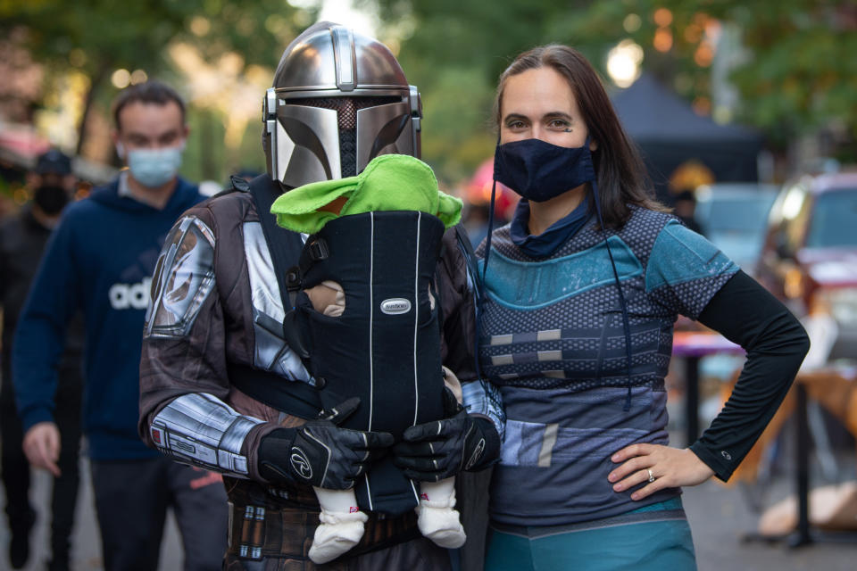 NEW YORK, NEW YORK - OCTOBER 31: A family dressed as Disney Plus' The Mandalorian poses in the East Village on October 31, 2020 in New York City. Many Halloween events have been canceled or adjusted with additional safety measures due to the ongoing coronavirus (COVID-19) pandemic. (Photo by Alexi Rosenfeld/Getty Images)