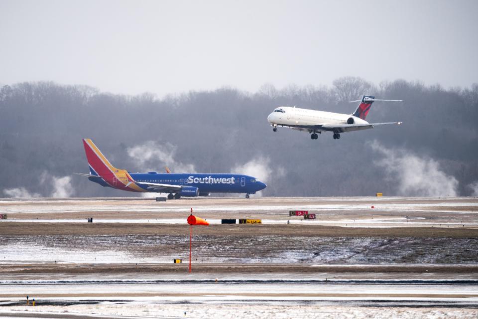 A Delta Airlines flight lands next to a Southwest Airlines flight at Nashville International Airport. Southwest announced Aug. 14 that Nashville will be home to its newest crew base.