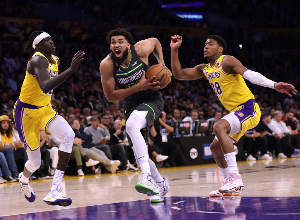 LOS ANGELES, CALIFORNIA - APRIL 11: Karl-Anthony Towns #32 of the Minnesota Timberwolves drives to the basket between Wenyen Gabriel #35 and Rui Hachimura #28 of the Los Angeles Lakers during the first half in a play-in tournament game at Crypto.com Arena on April 11, 2023 in Los Angeles, California. NOTE TO USER: User expressly acknowledges and agrees that, by downloading and or using this photograph, User is consenting to the terms and conditions of the Getty Images License Agreement. (Photo by Harry How/Getty Images)