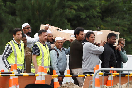 People attend the burial ceremony of Hussein Mohamed Khalil Moustafa, 70, a victim of the mosque attacks, at the Memorial Park Cemetery in Christchurch, New Zealand March 21, 2019. REUTERS/Edgar Su