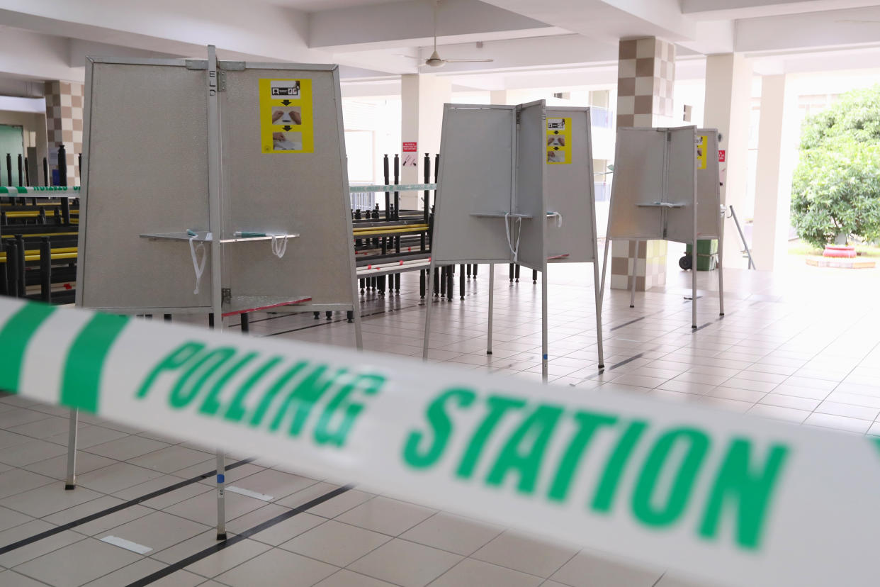 In this handout photo provided by the Ministry of Communications and Information, polling stations have been set up at Chung Cheng high school Thursday, July 9, 2020 in Singapore.  Friday's general election in Singapore will be the first in Southeast Asia since the coronavirus pandemic began, with the health crisis and a grim economy expected to bolster Prime Minister Lee Hsien Loong's party and extend its unbroken rule. (Singapore Ministry of Communications and Information via AP)