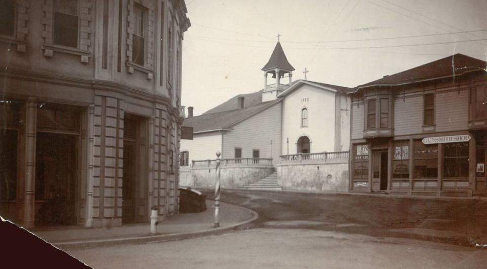 The San Luis Obispo Mission as seen in a photo from sometime around 1900. At left is the Lasar Building or Mission Garage, originally built around 1880. For part of the 1880s, the second floor housed the Morning Tribune newspaper. The building was torn down in 1955. To the right is a real estate office and gunsmith shop torn down in the 1950s.