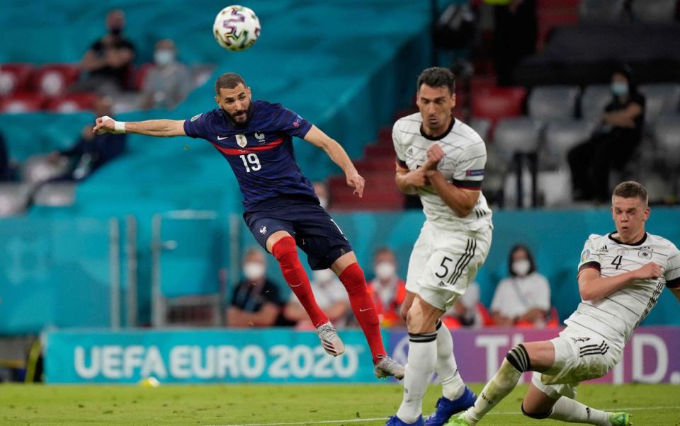 France's forward Karim Benzema (L) attempts a shot as he is marked by Germany's defender Mats Hummels (C) and Germany's defender Matthias Ginter during the UEFA EURO 2020 Group F football match between France and Germany at the Allianz Arena in Munich on June 15 - GETTY IMAGES