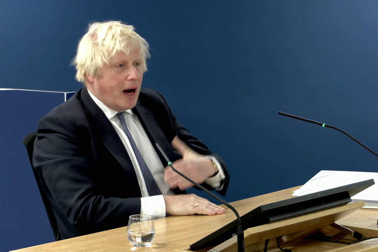 A video grab from footage broadcast by the UK Covid-19 Inquiry shows Britain's former Prime Minister Boris Johnson giving evidence at the UK Covid-19 Inquiry, in west London, on December 7, 2023. The former UK leader, who has faced a barrage of criticism from ex-aides for alleged indecisiveness and lack of scientific understanding during the pandemic, is attending the second of two gruelling days in the witness box. (Photo by UK Covid-19 Inquiry / AFP) / XGTY / RESTRICTED TO EDITORIAL USE - MANDATORY CREDIT 