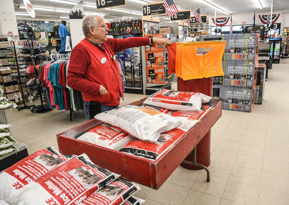 Employee Bob Cook looks at snow shovels and bags of ice melter while people buy items at White Jones Ace Hardware on North Main Street in Anderson, as snow is in the forecast for Sunday, and people prepare for it in Anderson, S.C. Wednesday, January 12, 2022. 