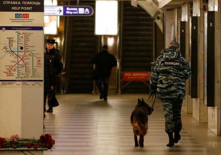 A police officer walks with a dog at Tekhnologicheskiy institut metro station in St. Petersburg, Russia, April 4, 2017. REUTERS/Grigory Dukor