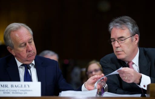 Chief Executive Retail Banking and Wealth Manaegment for HSBC Hong Kong Paul Thurston (R) and Head of Group compliance HSBC England David Bagley (L) look through evidence exhibits during a hearing on Capitol Hill in Washington, July 17. , 2012. AFP PHOTO/Jim WATSON