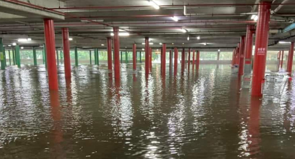 Morayfield Shopping Centre's underground car park is flooded with the water coming up high against the red structural columns. 