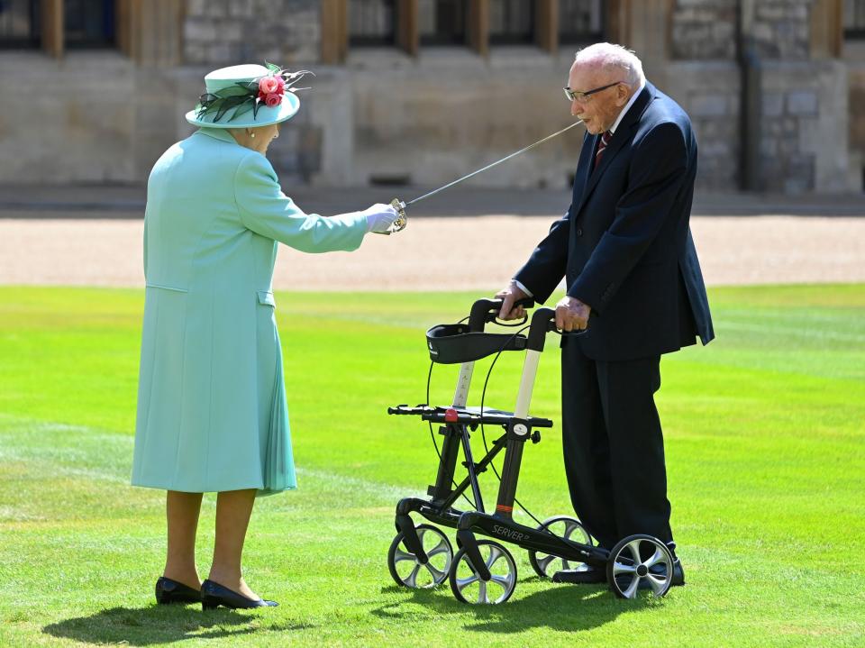 The Queen knights Tom Moore at Windsor Castle in July last yearRex