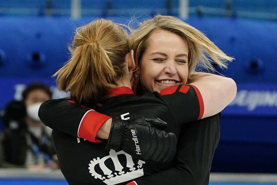 Denmark's Madeleine Dupont hugs her teammate after a win against China after a women's curling match at the Beijing Winter Olympics Thursday, Feb. 10, 2022, in Beijing. (AP Photo/Brynn Anderson)