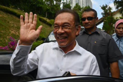 Anwar Ibrahim waves in Kuala Lumpur before announcing he was the preferred candidate of a parliamentary coalition