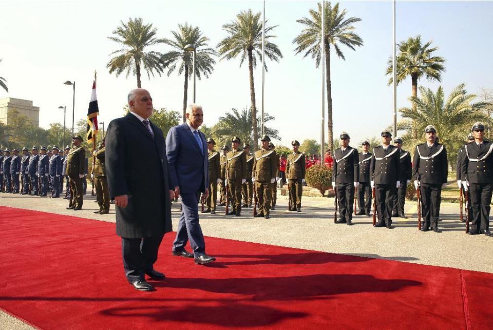 Iraq's Prime Minister Haider al-Abadi, left, and Turkish Prime Minister Binali Yildirim inspect honour guard during a welcome ceremony in Baghdad, Iraq, Saturday, Jan. 7, 2017. Yildirim is in Iraq for a two-day visit.(Hakan Goktepe, Prime Minister's Press Service, Pool photo via AP)