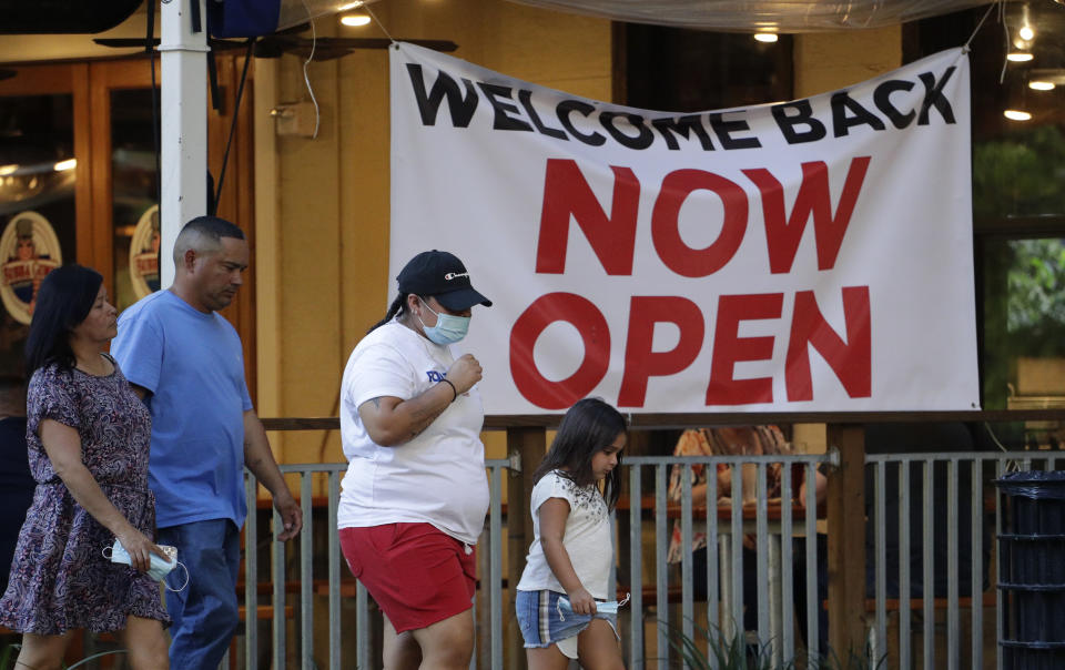 Visitors to the River Walk pass a restaurant that has reopened in San Antonio, Wednesday, May 27, 2020. Texas continues to reopen in the wake of the COVID-19 pandemic. (AP Photo/Eric Gay)