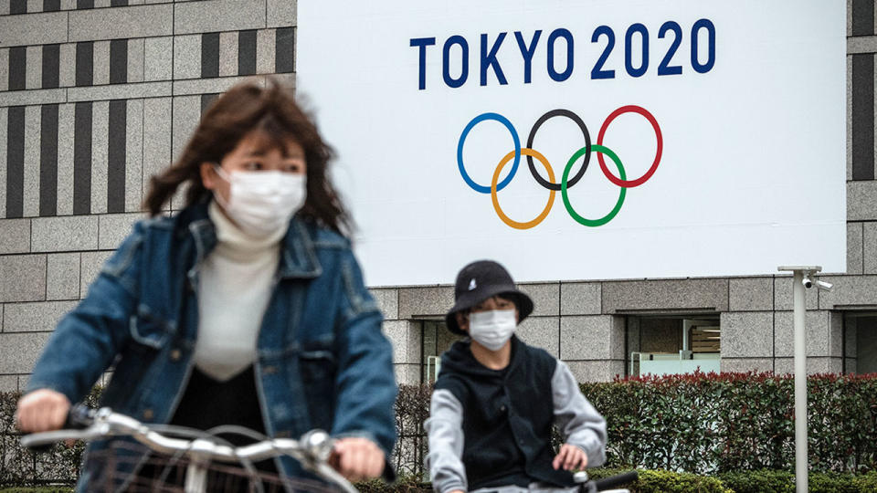 Locals in Tokyo wear face masks in response to the coronavirus pandemic. 