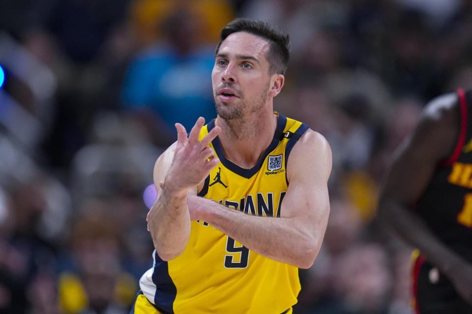 Indiana Pacers guard T.J. McConnell (9) celebrates after a three-point basket against the Atlanta Hawks during the first half of an NBA basketball game in Indianapolis, Sunday, April 14, 2024. (AP Photo/Michael Conroy)