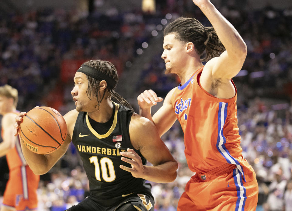 Vanderbilt guard Jordan Williams (10) drives past Florida guard Walter Clayton Jr., right, during the first half of an NCAA college basketball game Saturday, Feb. 24, 2024, in Gainesville, Fla. (AP Photo/Alan Youngblood)