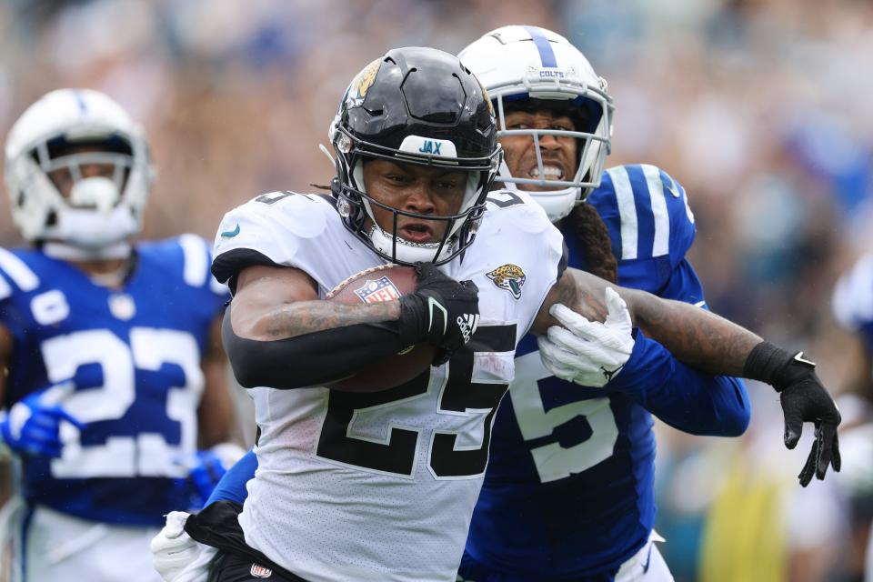 Jacksonville Jaguars running back James Robinson (25) outpaces Indianapolis Colts cornerback Stephon Gilmore (5) en route to a touchdown score during the second quarter of a regular season game Sunday, Sept. 18, 2022 at TIAA Bank Field in Jacksonville. [Corey Perrine/Florida Times-Union]