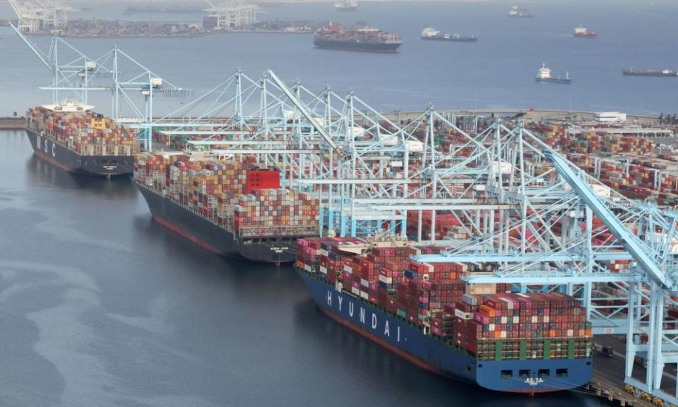 Shipping containers are unloaded at the Los Angeles port on 7 April.