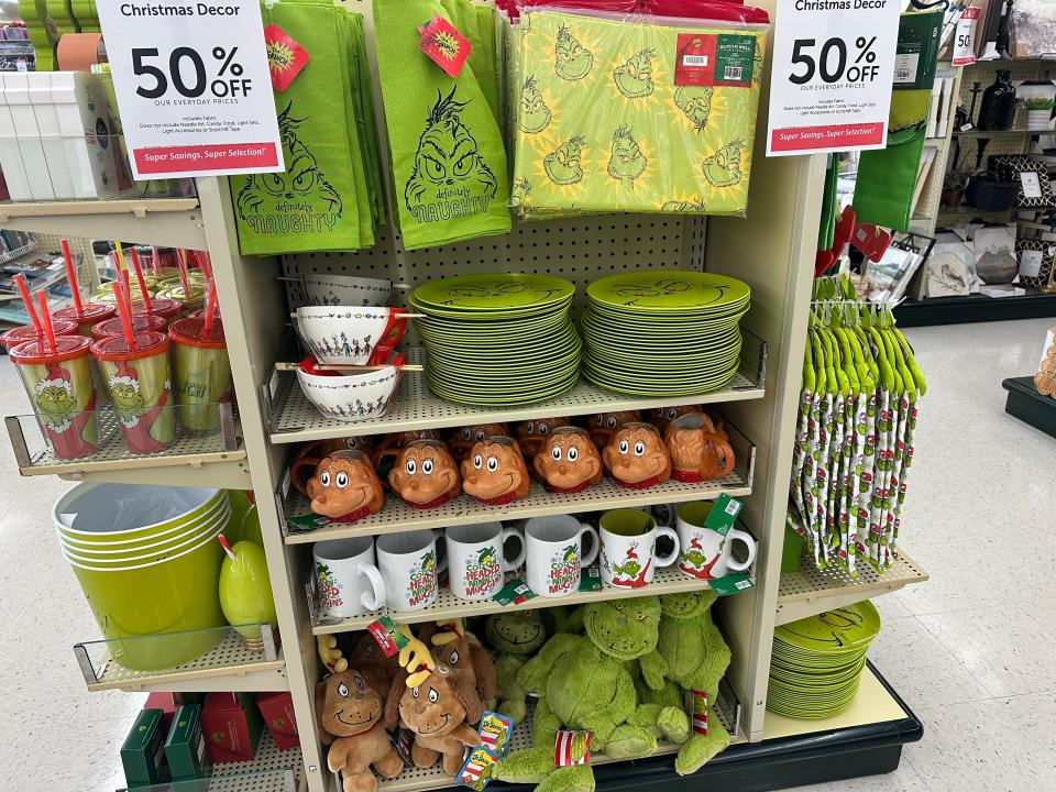 Grinch-themed plates, mugs, and towels on display in Hobby Lobby