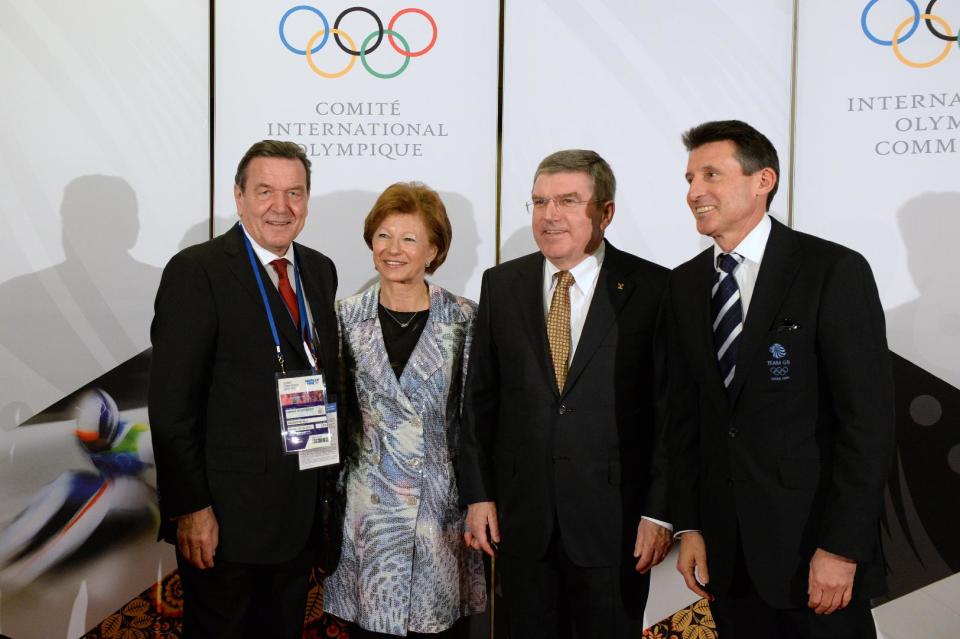 International Olympic Committee President Thomas Bach, second from right, and his wife Claudia, second from left, pose with former German Chancellor Gerhard Schroeder, left, and former British athlete and chairman of the London 2012 Olympic committee Sebastian Coe before the IOC President's Gala Dinner on the eve of the opening ceremony of the 2014 Winter Olympics, Thursday, Feb. 6, 2014, in Sochi, Russia. (AP Photo/Andrej Isakovic, Pool)