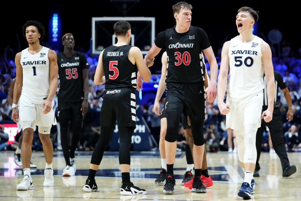 Cincinnati Bearcats forward Viktor Lakhin (30) takes exception to something said by Xavier Musketeers forward Gytis Nemeiksa (50) in the second half of the 91st Crosstown Shootout basketball game between the Cincinnati Bearcats and the Xavier Musketeers, Saturday, Dec. 9, 2023, at Cintas Center in Cincinnati. The Xavier Musketeers won, 84-79.