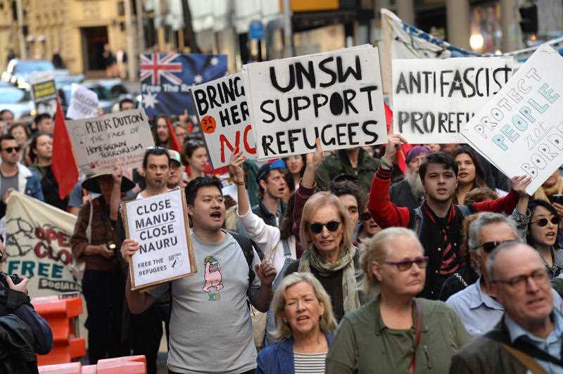 Protesters march through the central business district in Sydney calling for an end to offshore detention centres.