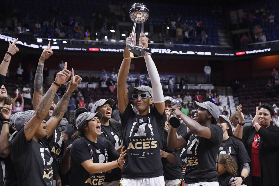 FILE - Las Vegas Aces' A'ja Wilson holds up the championship trophy as she celebrates with teammates after their win in the WNBA basketball finals against the Connecticut Sun, Sept. 18, 2022, in Uncasville, Conn. The Las Vegas Aces are having a historic season so far, but anything short of repeating as WNBA champions would be seen as a failure. (AP Photo/Jessica Hill, File)