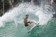 Surfer Italo Ferreira from Brazil works out on a Surf Ranch wave during practice rounds for the upcoming Olympics Tuesday, June 15, 2021, in Lemoore, Calif. This year, Ferreira and fellow Brazilian Gabriel Medina are expected to rule the men's competition at surfing's long-awaited debut as an Olympic sport in the Tokyo 2020 Games. While the surfing community has long pledged that the ocean is for everyone, a look at the professional ranks show a sport that remains expensive and inaccessible. A series of recent industry efforts to help groom the next generation outside of the usual hot spots of Hawaii, California and Australia look to be a tacit acknowledgement of the existing disparities among its talent bench.(AP Photo/Gary Kazanjian)