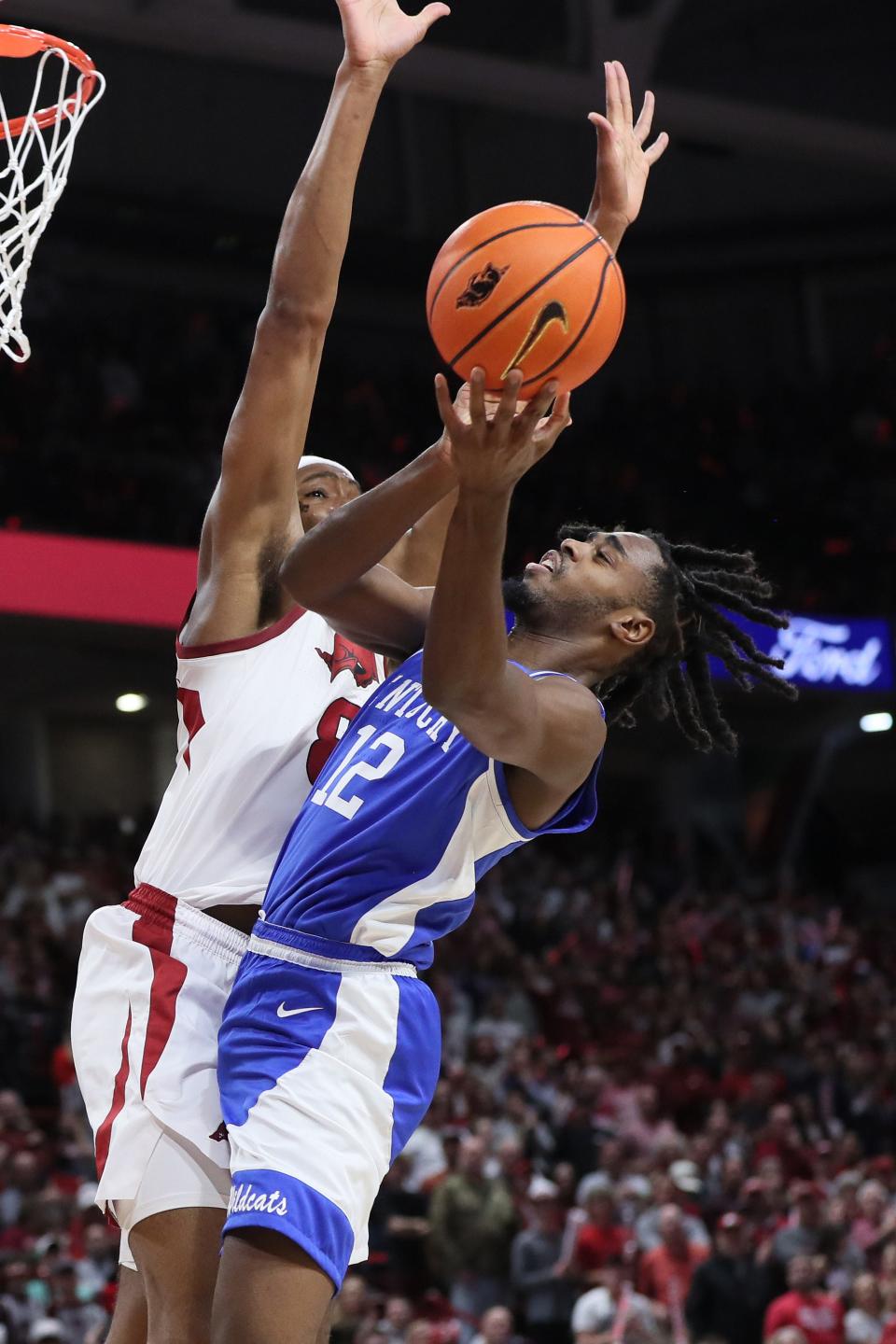 Wildcats guard Antonio Reeves shoots in the first half against the host Razorbacks. Reeves scored a game-high 24 points in the Wildcats' 63-57 victory Saturday night.