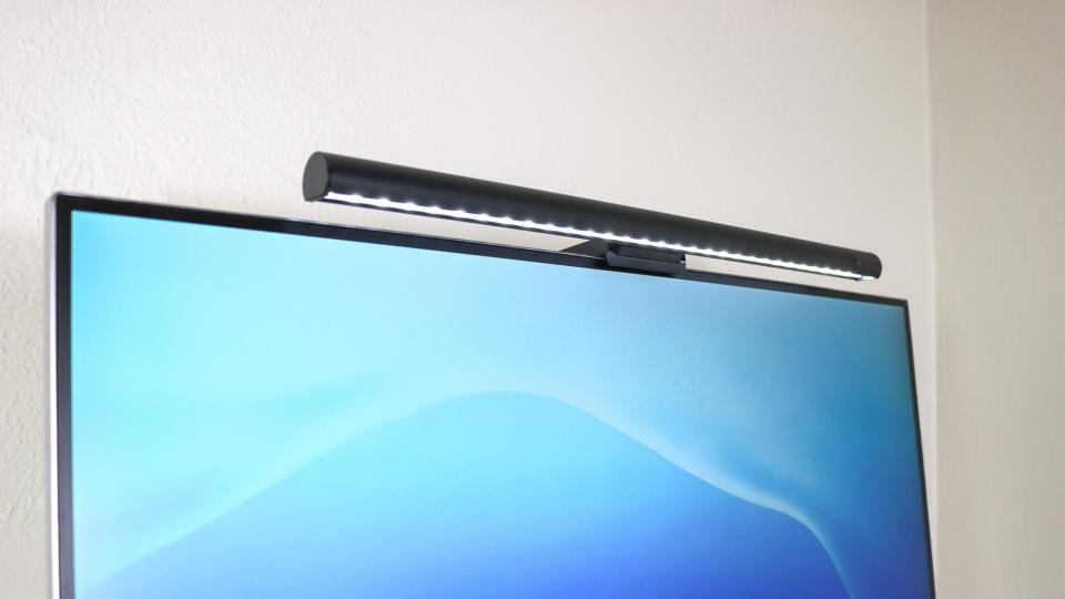 A close up shot of a monitor light bar installed on top of a monitor