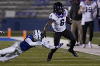 TCU running back Zach Evans (6) gets past Kansas cornerback Elijah Jones (4) during the first half of an NCAA college football game in Lawrence, Kan., Saturday, Nov. 28, 2020. (AP Photo/Orlin Wagner)