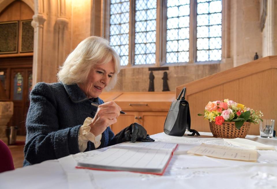 The Duchess of Cornwall signs the visitor’s book (Finnbarr Webster/PA) (PA Wire)