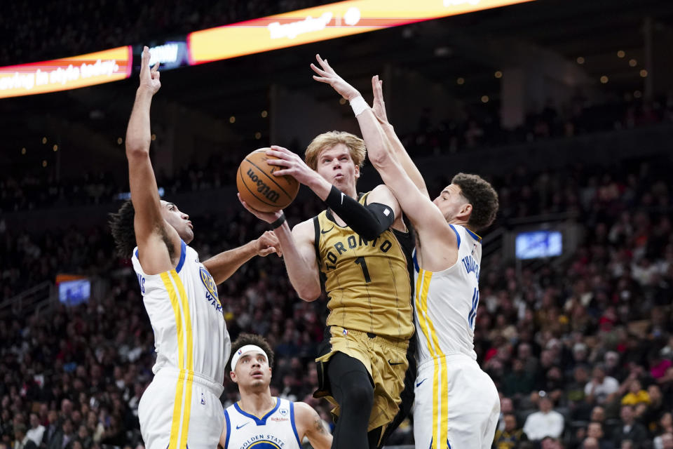 Toronto Raptors guard Gradey Dick (1) jumps as Golden State Warriors guard Klay Thompson, right, defends during the second half of an NBA basketball game, in Toronto on Friday, March 1, 2024. (Arlyn McAdorey/The Canadian Press via AP)