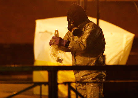 FILE PHOTO: Members of the emergency services wearing protective clothing work near the bench where former Russian intelligence officer Sergei Skripal and his daughter Yulia were found poisoned in Salisbury, Britain, March 13, 2018. REUTERS/Henry Nicholls/File Photo