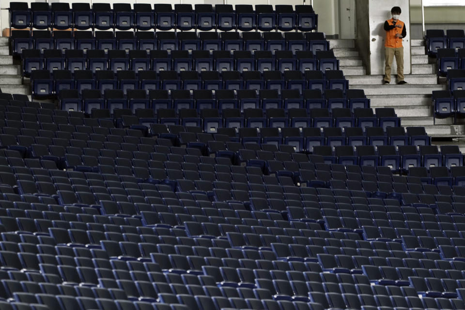 Spectator stands are empty during play in a preseason baseball game between the Yomiuri Giants and the Yakult Swallows at Tokyo Dome in Tokyo Saturday, Feb. 29, 2020. Japan's professional baseball league said Thursday it will play its 72 remaining preseason games in empty stadiums because of the threat of the spreading coronavirus. (AP Photo/Eugene Hoshiko)