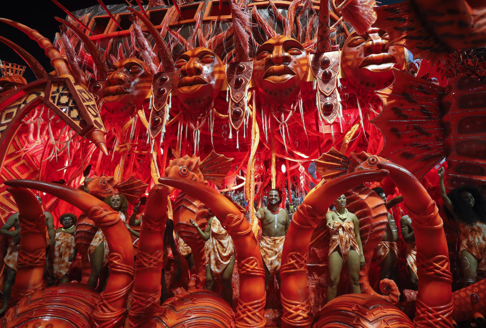 Dancers from the Tom Maior samba school perform on a float during a carnival parade in Sao Paulo early Saturday, Feb. 22, 2020. (AP Photo/Andre Penner)