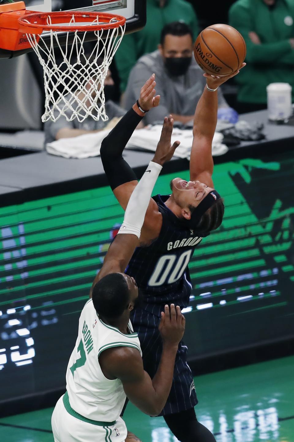 Orlando Magic's Aaron Gordon (00) shoots against Boston Celtics' Jaylen Brown (7) during the first half of an NBA basketball game, Sunday, March 21, 2021, in Boston. (AP Photo/Michael Dwyer)