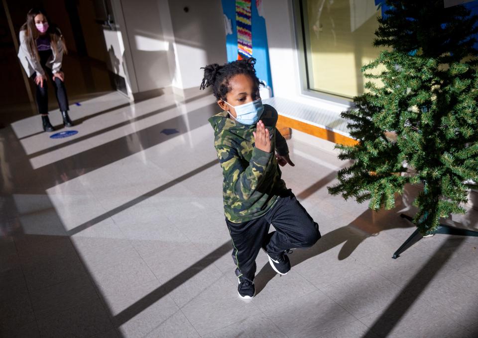 Adonus McGruder, 6, a first-grader at Enos Elementary School, takes off in a sprint Thursday as he shows Khloe Sandercock, left, of Rochester, a fourth-year medical student at the SIU School of Medicine, how well he can run in his new shoes after receiving them during SIU's participation in the national "Shoes That Fit" program at the elementary school. "It gives me chills," said Sandercock as she saw McGruder running in his new shoes. "It makes my heart beat so fast that I can just tell that they are so excited and grateful." More than 85 students at McClernand and Enos elementary schools received shoes and socks through funds raised by SIU Medical students. "It's so fun just to see their smiles and watch them run as fast they can in their new shoes. To see what they can do and the confidence that it gives them, it's amazing," Sandercock said. [Justin L. Fowler/The State Journal-Register]