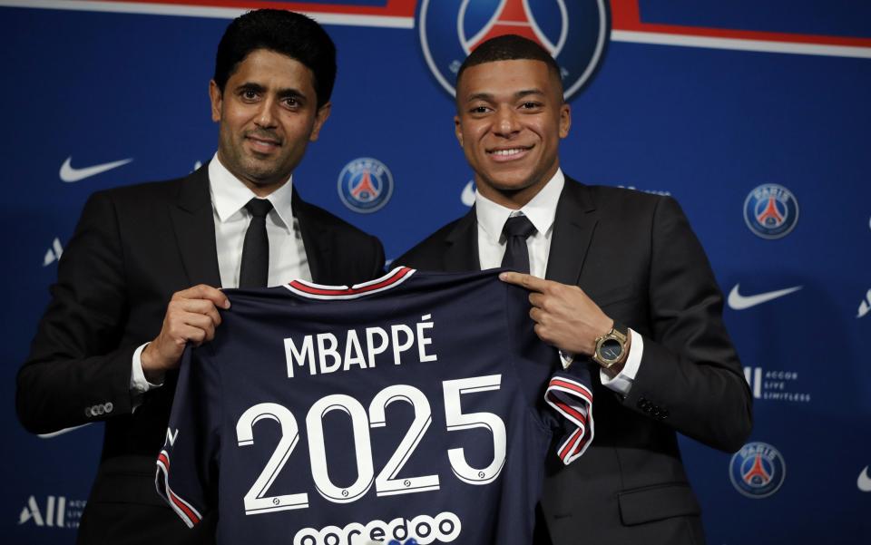 Paris Saint-Germain's president Nasser Al-Khelaifi (L) and Paris Saint Germain's forward Kylian Mbappe pose with a PSG jersey during a press conference at the Parc des Princes stadium in Paris, France, 23 May 2022. Kylian Mbappe renewed his contract with French Ligue 1 soccer club Paris Saint-Germain until 2025. Kylian Mbappe presser in Paris, France