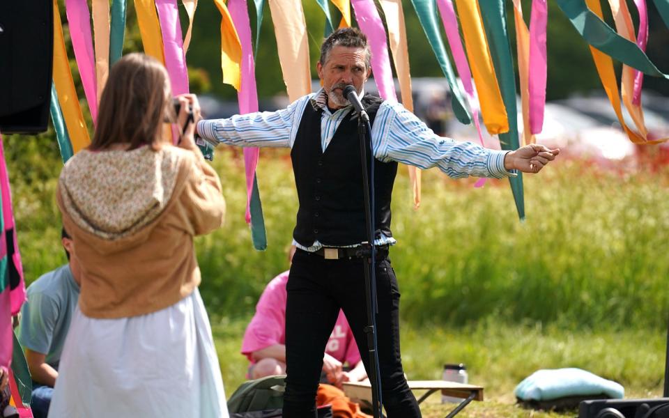 A member of Animal Rising protest group speaks outside the entrance during Derby Day of the 2023 Derby Festi - PA/Mike Egerton