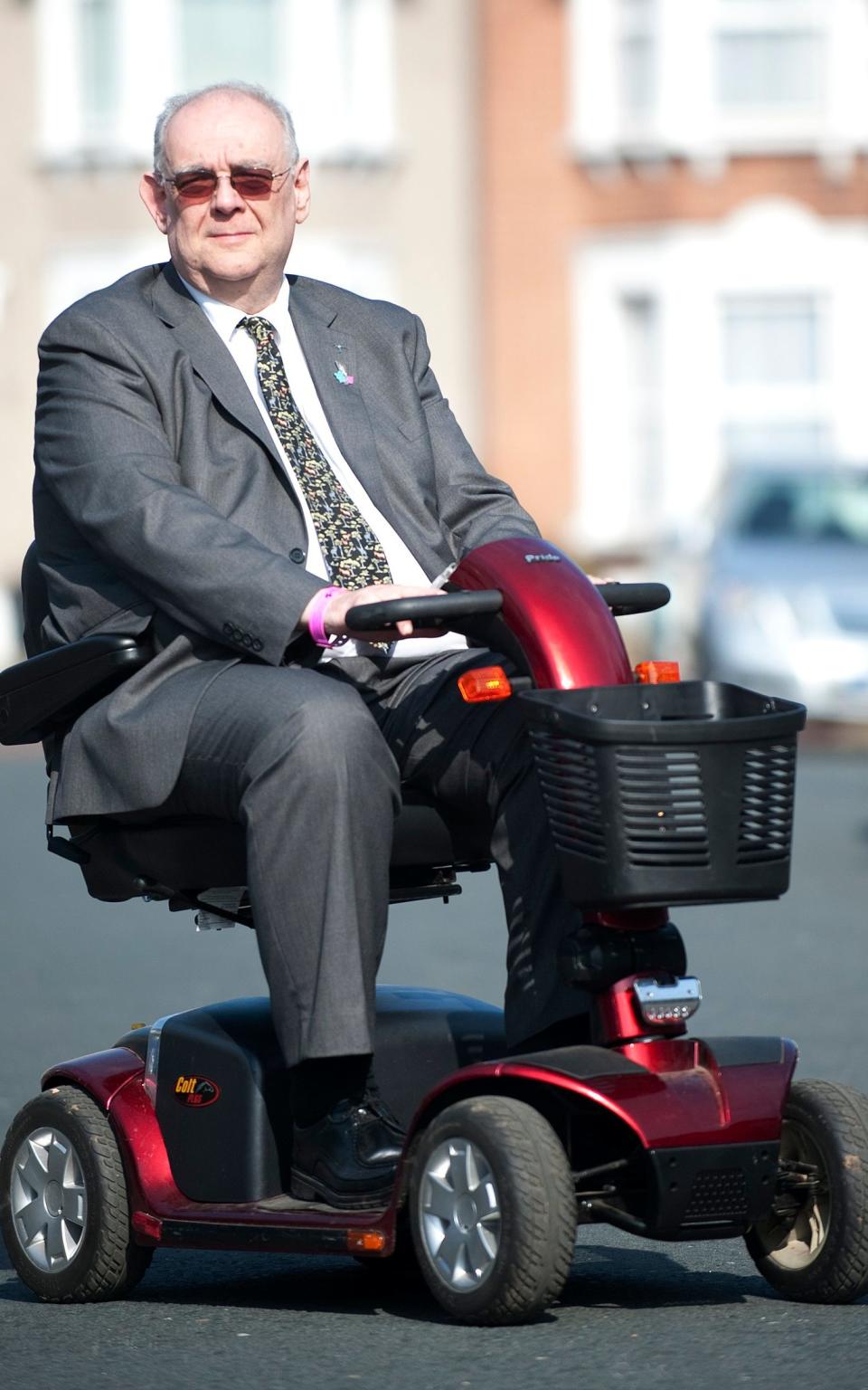 David Miller on his mobility scooter - Credit: Eddie Mulholland for the Telegraph